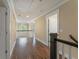 Upstairs hallway showcasing hardwood floors, natural light, and views of the stairwell at 550 Vinings Springs Se Dr, Smyrna, GA 30126