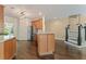 Kitchen with wooden cabinetry, stainless steel appliances, island, and hardwood floors at 550 Vinings Springs Se Dr, Smyrna, GA 30126