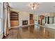 Spacious living area with a fireplace, built-in shelves, hardwood flooring, and an open layout at 550 Vinings Springs Se Dr, Smyrna, GA 30126