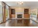 Inviting living area showcases a fireplace, built-in shelves, and large windows at 550 Vinings Springs Se Dr, Smyrna, GA 30126