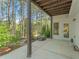 Outdoor patio showcases concrete flooring with wooded views and a door leading into the home at 550 Vinings Springs Se Dr, Smyrna, GA 30126
