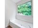 Bright bathroom featuring a garden tub and large window with wooded views at 87 Fair Havens Dr, Hiram, GA 30141
