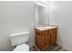 Powder room with wood-look floor, wooden vanity, and mounted mirror at 87 Fair Havens Dr, Hiram, GA 30141