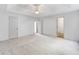 Spacious bedroom with neutral carpet, ceiling fan, and multiple doors at 87 Fair Havens Dr, Hiram, GA 30141