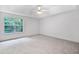 Spacious primary bedroom with large window and neutral decor at 87 Fair Havens Dr, Hiram, GA 30141