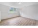 Bedroom with laminate floor, bright window, and white door at 87 Fair Havens Dr, Hiram, GA 30141