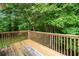 Wooden deck with wooden railing looking out into a backyard with mature trees at 87 Fair Havens Dr, Hiram, GA 30141