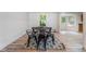 Chic dining area with modern black chairs and an elegant table, set upon stylish flooring and a patterned rug at 87 Fair Havens Dr, Hiram, GA 30141