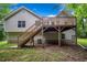 Backyard view of home showcasing a wooden deck with stairs and mature trees at 87 Fair Havens Dr, Hiram, GA 30141