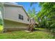 Backyard view of the home showcasing a wooden deck with stairs, mature trees and green grass at 87 Fair Havens Dr, Hiram, GA 30141