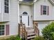 Close-up of the front door, framed by wooden railings and sidelights, leading to the home's welcoming entrance at 87 Fair Havens Dr, Hiram, GA 30141