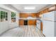 Bright kitchen features wood cabinets, black appliances, and durable floors, with a door to the outdoor space at 87 Fair Havens Dr, Hiram, GA 30141
