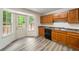 Well-lit kitchen with wood cabinets, black appliances, and a convenient door to the outdoor deck at 87 Fair Havens Dr, Hiram, GA 30141