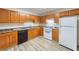 Well-lit kitchen features wood cabinetry, modern appliances, and durable flooring, providing a functional cooking space at 87 Fair Havens Dr, Hiram, GA 30141