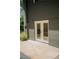 Exterior view of the walkout basement french doors, concrete patio, and neutral-painted brick at 2524 Glenrock Dr, Decatur, GA 30032