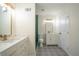 Bright modern bathroom with dual sink vanities, green tiled shower, and patterned tile floor at 2524 Glenrock Dr, Decatur, GA 30032
