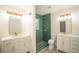 Brightly lit renovated bathroom showing dual vanities, green tiled shower, and patterned tile flooring at 2524 Glenrock Dr, Decatur, GA 30032