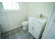 Bathroom featuring patterned floors, toilet, vanity, and subway tile at 2524 Glenrock Dr, Decatur, GA 30032