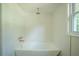A modern bathroom featuring a soaking tub, subway tile, and gold fixtures at 2524 Glenrock Dr, Decatur, GA 30032