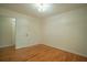 Neutral bedroom featuring hardwood floors, a double-panel interior door, and a flush mount light fixture at 2524 Glenrock Dr, Decatur, GA 30032