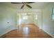 An open and airy bedroom boasts hardwood floors, a ceiling fan, and natural light from several windows at 2524 Glenrock Dr, Decatur, GA 30032