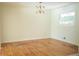 Empty dining room with natural light, hardwood floors, and an elegant chandelier, ready for personalization at 2524 Glenrock Dr, Decatur, GA 30032