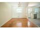 Dining room with classic light fixture and hardwood floors, adjacent to a renovated kitchen with updated appliances at 2524 Glenrock Dr, Decatur, GA 30032