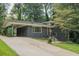 Charming one story home with a dark gray brick exterior, car port, and landscaped front yard at 2524 Glenrock Dr, Decatur, GA 30032