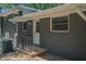 Exterior of house with gray painted brick, white trim, black railing, and HVAC unit at 2524 Glenrock Dr, Decatur, GA 30032
