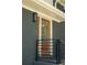 Close up of the front door with stained wood finish, modern light fixture, and black railing at 2524 Glenrock Dr, Decatur, GA 30032