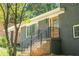 Elegant entrance featuring a wood door, dark gray brick, and black railings at 2524 Glenrock Dr, Decatur, GA 30032