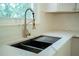 Modern kitchen sink with gold faucet and white quartz countertop, with window view at 2524 Glenrock Dr, Decatur, GA 30032