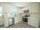 Modern kitchen with white cabinets, stainless steel appliances, patterned floors, and ample counter space for meal preparation at 2524 Glenrock Dr, Decatur, GA 30032
