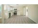 Updated kitchen features white cabinets, stainless steel appliances, and unique patterned flooring at 2524 Glenrock Dr, Decatur, GA 30032