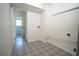 Clean and organized laundry room with new patterned tile flooring and hook ups at 2524 Glenrock Dr, Decatur, GA 30032