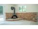Close up of a living room with a vintage fireplace and brick accent wall at 2524 Glenrock Dr, Decatur, GA 30032