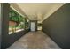 Covered patio with stained concrete floor, neutral painted brick, and recessed lights at 2524 Glenrock Dr, Decatur, GA 30032