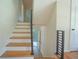 Open staircase featuring wood treads, white risers, and a contemporary metal railing, leading to the upper level at 2524 Glenrock Dr, Decatur, GA 30032