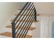 Modern staircase with wooden steps and a black metal railing, providing a sleek and stylish transition between floors at 2524 Glenrock Dr, Decatur, GA 30032