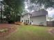 Spacious backyard with a wooden deck, lush lawn, and mature trees for privacy at 4638 Villa Chase Ne Dr, Marietta, GA 30068