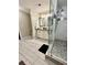 Bright bathroom featuring double sink vanity, glass shower with pebble floor and light gray flooring at 4638 Villa Chase Ne Dr, Marietta, GA 30068