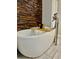 Freestanding soaking tub with wood accent wall and chrome faucet fixtures at 4638 Villa Chase Ne Dr, Marietta, GA 30068