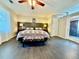 Spacious main bedroom featuring a decorative ceiling fan and dark wood flooring throughout at 4638 Villa Chase Ne Dr, Marietta, GA 30068