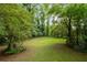 Expansive backyard with lush greenery and natural surroundings at 5414 Iris Sw Dr, Mableton, GA 30126
