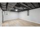 Spacious basement area with light wood flooring, drop ceiling and a window at 5414 Iris Sw Dr, Mableton, GA 30126