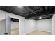 Finished basement area with light-colored walls, floors, and painted, exposed ceiling at 5414 Iris Sw Dr, Mableton, GA 30126