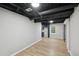 Finished basement with light-colored walls, wood-look flooring, and a kitchenette area at 5414 Iris Sw Dr, Mableton, GA 30126
