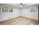 Bright bedroom with new floors, two windows, and ceiling fan at 5414 Iris Sw Dr, Mableton, GA 30126