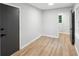 Bedroom with modern style door and view of window and hardwood floors at 5414 Iris Sw Dr, Mableton, GA 30126