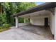 Spacious carport with brick lattice and an entrance door to the home at 5414 Iris Sw Dr, Mableton, GA 30126
